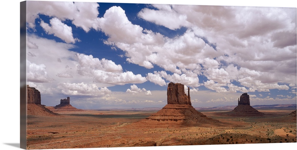 Horizontal photo on canvas of rock monuments in a desert in Arizona.