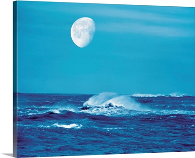 Moon over waves in sea