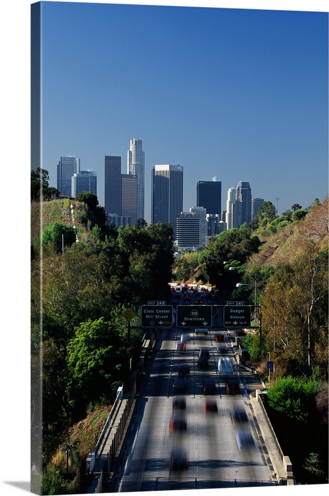 This large vertical piece is a photograph taken of the Pasadena freeway during a morning commute. The city is pictured in ...