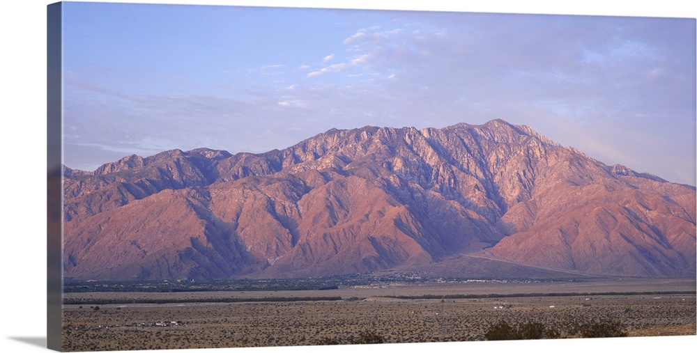 Wide angle picture of San Jacinto Peak in California. The sun is setting out of view and shining onto the mountain range.