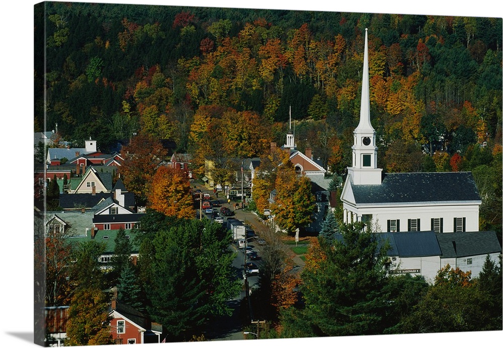 Large photo of fall foliage surrounding a small town in Vermont with an old Church on the right.