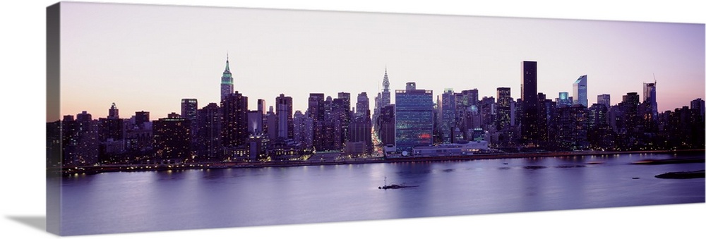 Panoramic wall docor of the New York City cityscape along a waterfront at sunset.