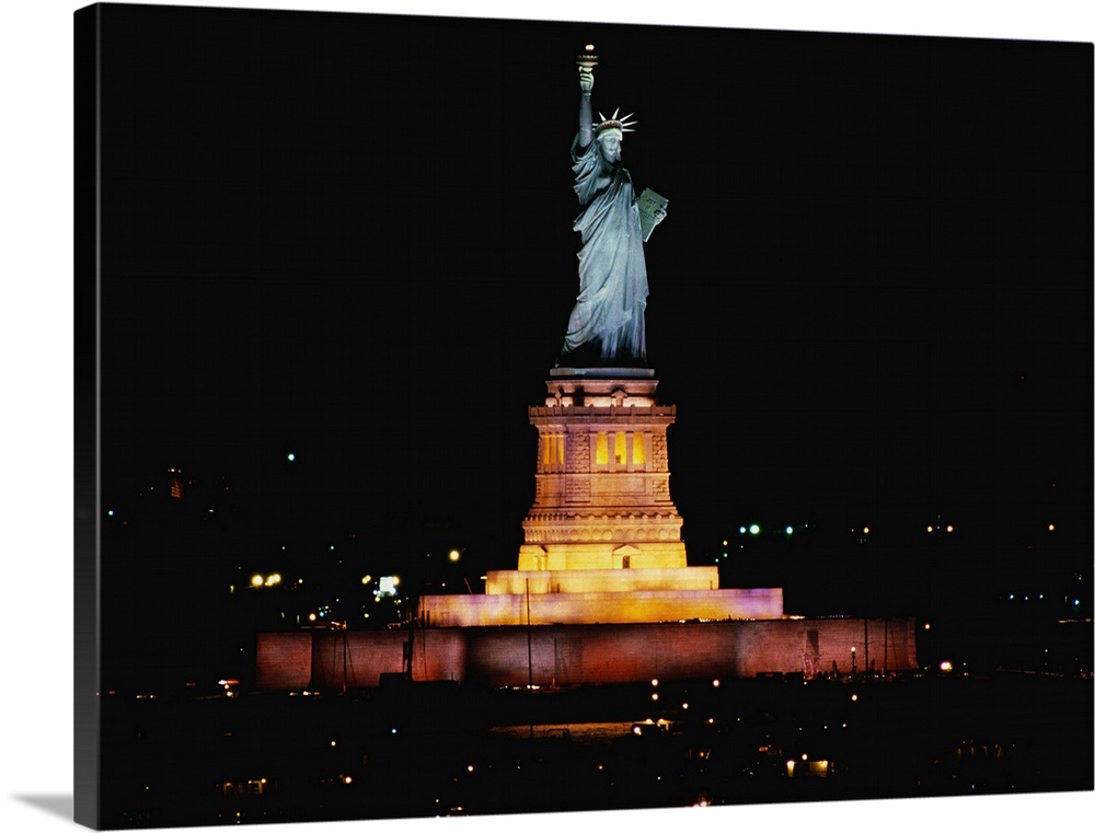 Big photo on canvas of the Statue of Liberty at night lit up.