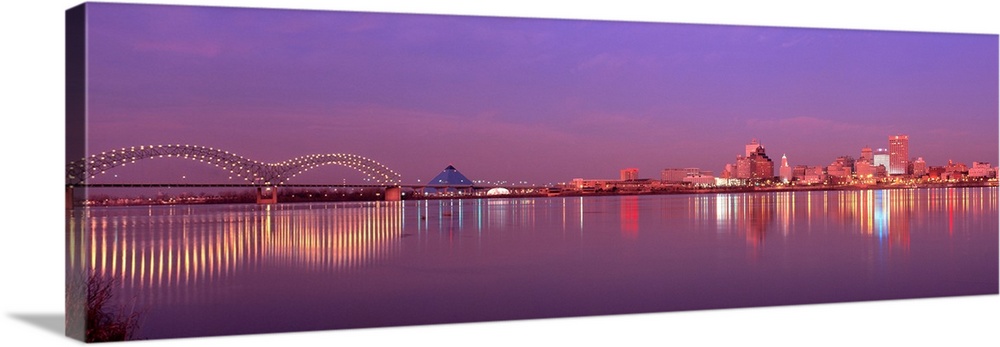 This photographic wall art a panoramic cityscape of Memphis lights reflecting on the Mississippi River at dusk.