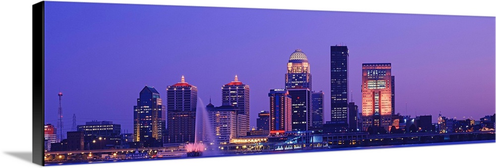 Panoramic photo on canvas of a cityscape in Kentucky lit up at night along a waterfront.
