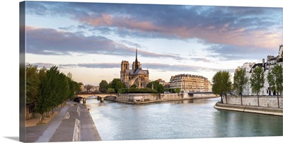 Notre Dame Cathedral on the banks of the Seine River at sunrise, Paris, France