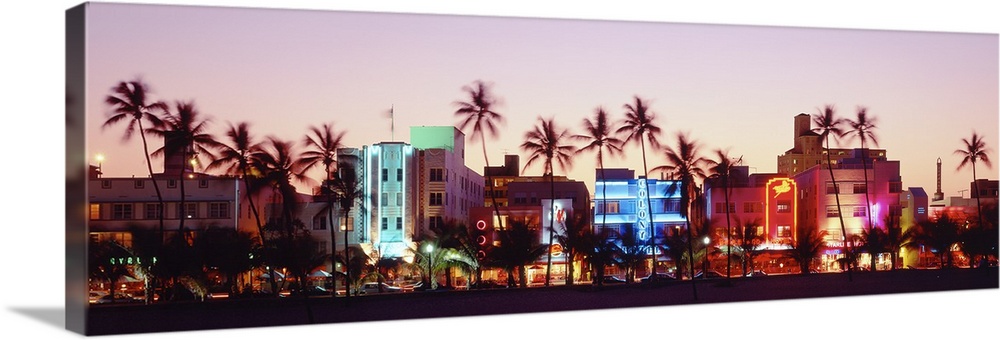 A panoramic photograph of a sunset featuring Miami's Ocean Drive and the neon lights of the Art Deco District.
