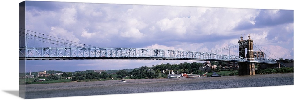 A panoramic view of Cincinnati's famous suspension bridge, the Roebling, which spans across the Ohio River.
