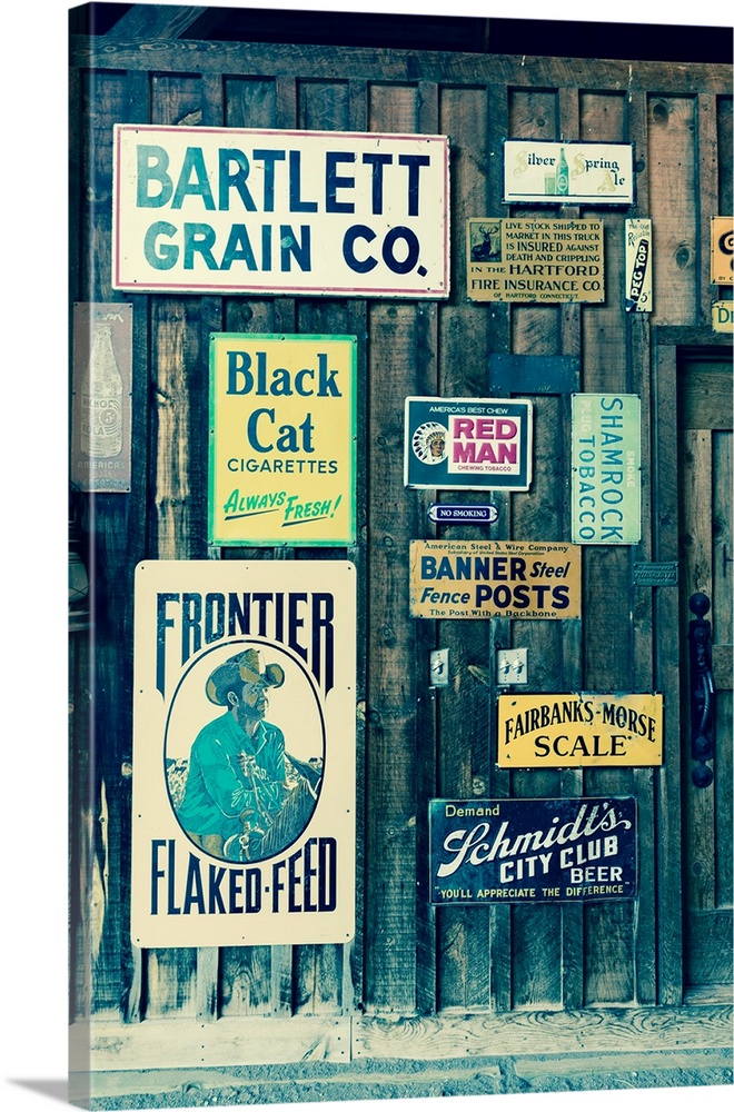 Old advertising signs posted in historic centennial ranch barn, ridgway, colorado - a designated historic landmark.