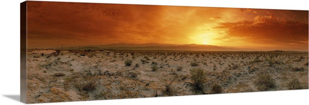 Big, horizontal photograph of a fiery sunset over the desert in Palm Springs, California.