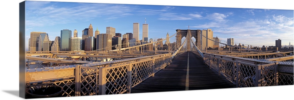 Panoramic view from the Brooklyn Bridge of walk into Manhattan with skyscrapers in the background.