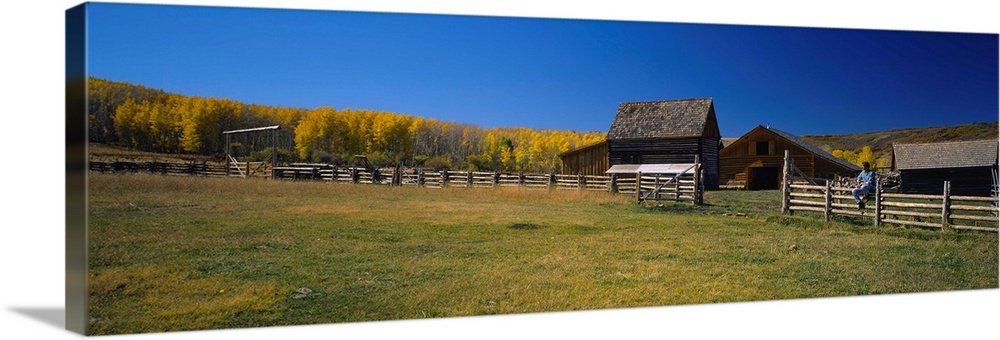 Person sitting on a fence, Last Dollar Ranch, Colorado