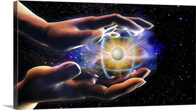 Person's hands holding an atom