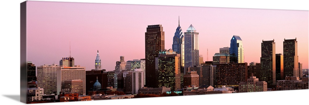 The skyline of Philadelphia, Pennsylvania against a hazy sunset sky.