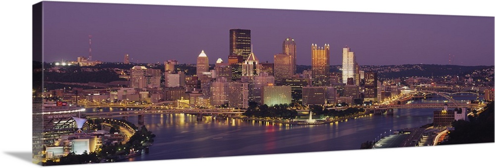 This oversized wall art is a panoramic photograph of the cityos downtown captured from the south above the river.