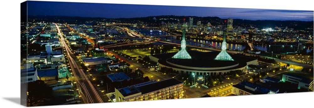 Oregon's most populous city lit up in the evening by the glowing lights of office buildings and traffic.