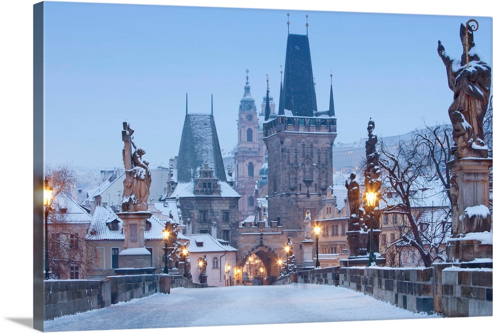 Prague, Charles Bridge tower and St. Nicolas church on winter morning.