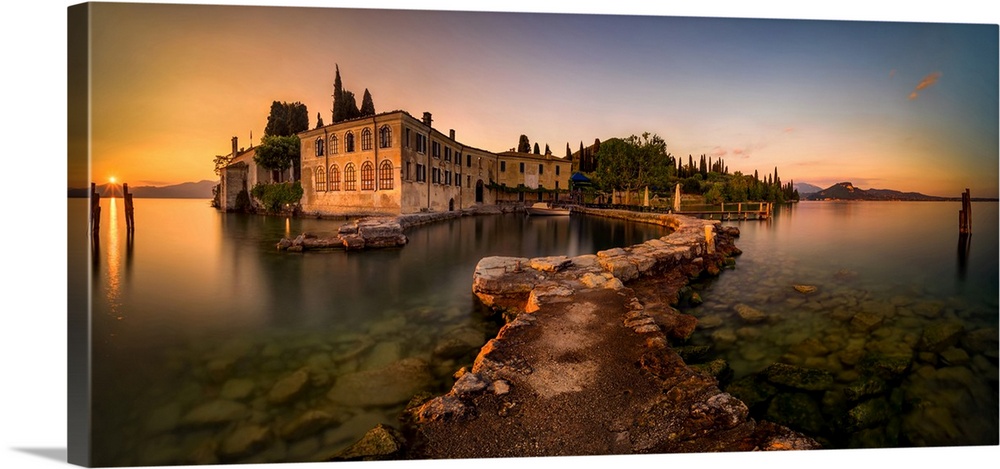 Punta san vigilio harbor at garda lake mountains in background, garda, Italy.