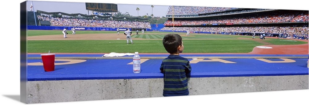 This decorative all wart is a panoramic photograph of a child watching a baseball game from a dug out.