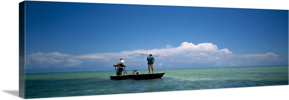 Rear view of a couple fishing in the sea, Islamorada, Florida Keys, Monroe County, Florida, USA