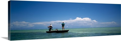 Rear view of a couple fishing in the sea, Islamorada, Florida Keys, Florida