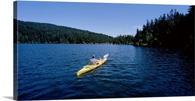 Rear view of a man on a kayak in a lake, Orcas Island, Washington State