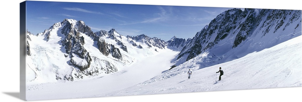 Rear view of two people skiing, Les Grands Montets, Chamonix, France