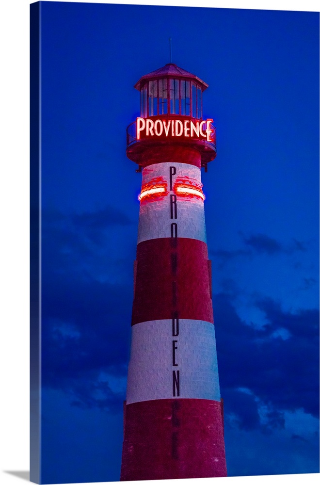 Red and white lighthouse shows neon sign saying providence, cedar city, utah.