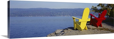 Red And Yellow Adirondack Chairs Near A Lake, Champlain Lake, Vermont