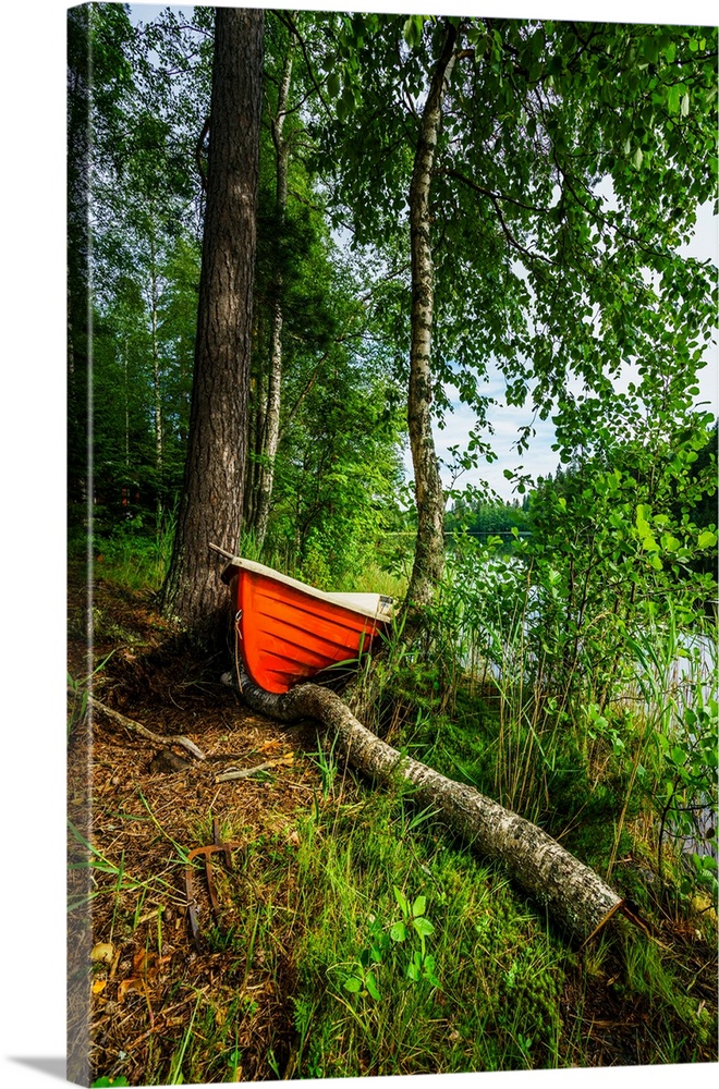 Red row boat in the forest, hogland island, finland.