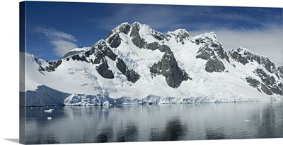 Reflection of a snow covered mountain in water, Antarctic Peninsula, Antarctica