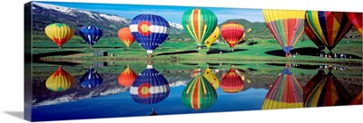 Reflection of hot air balloons on water, Colorado