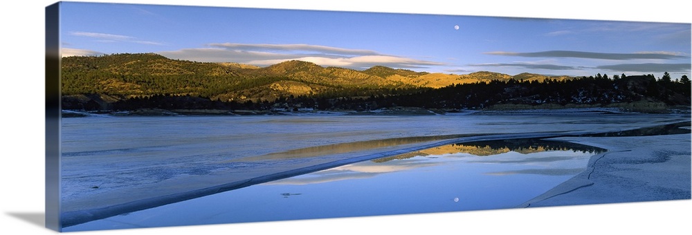 Large photo on canvas of a lake with rolling hills in the distance and a moon shining bright in the sky reflected on the l...