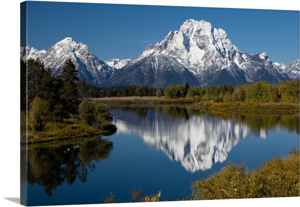 Reflection of mountain and trees on water, Teton Range, Grand Teton National Park, Wyoming, USA