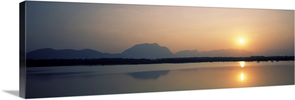 Reflection of sun in a lake, Western Ghats Hills, Tamil Nadu, India