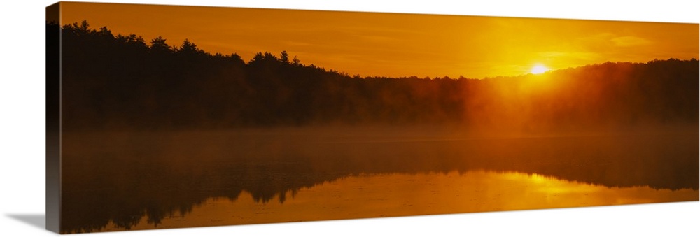 Reflection of sun in the pond at sunrise, Vermont