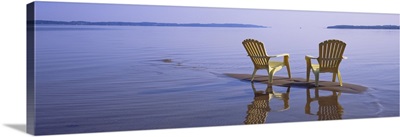 Reflection of two adirondack chairs in a lake, Lake Michigan, Michigan