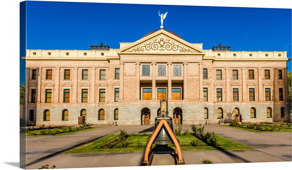 Replica of liberty bell in front of arizona state capitol building at sunrise, phoenix, arizona.