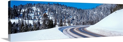 Road passing through a snow covered landscape, Big Sky Resort, Big Sky, Montana