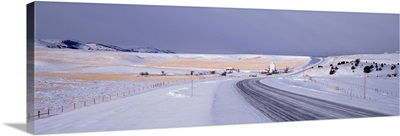Road passing through a snow covered landscape, Bozeman, Gallatin County, Montana