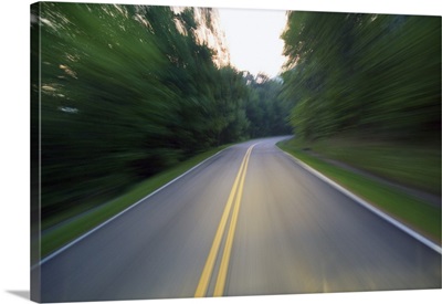 Road winding through forest at dusk, blurred motion, Great Smoky Mountains National Park, Tennessee