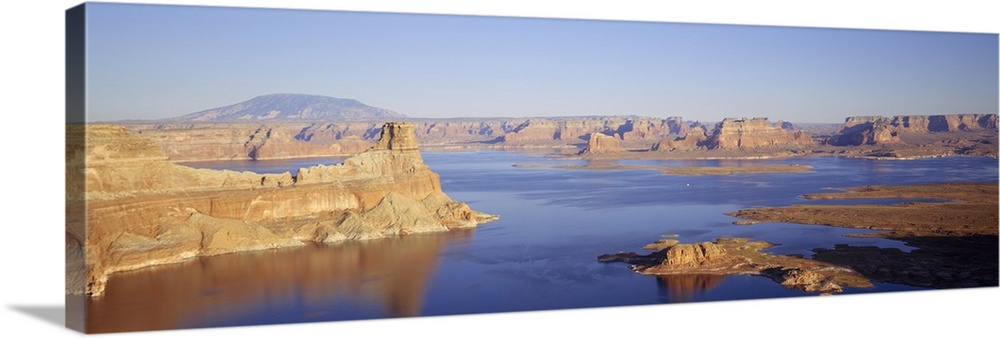 Panoramic photograph of huge rocks and canyons in river under a clear sky.