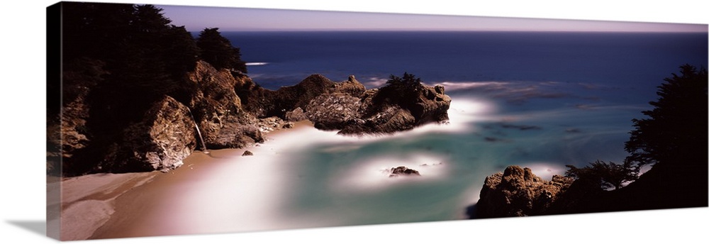 Larges rocks in the water and along the shore  of the Pacific Ocean in Big Sur, California.
