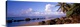 image thumbnail of Panoramic photograph displays a sandy beach filled with large rocks and palm trees on a sunny day.  In that distance the t...