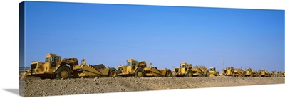 Row of bulldozers at a construction site