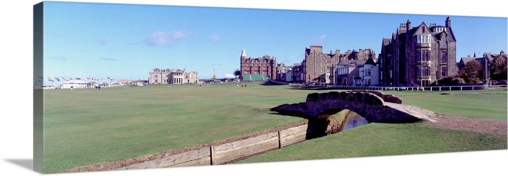 Panoramic photograph shows Swilcan Bridge connecting two fairways in The Royal and Ancient Golf Club of St. Andrews in Sco...