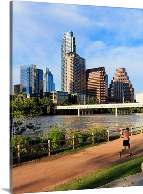 Runner on path along south shore of Lady Bird Lake in downtown Austin, Texas