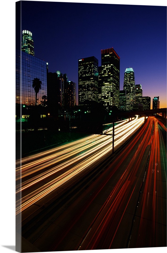 Vertical photograph of the light trails of cars on the Harbor Freeway in Los Angeles, California at night.