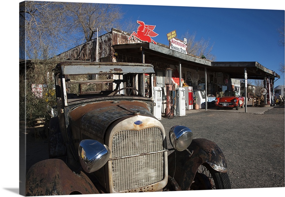 Photograph of vintage car at old garage and gas station.