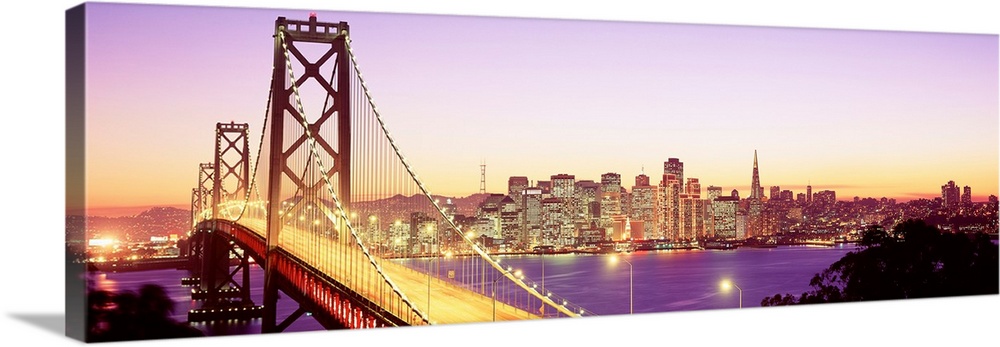 An aerial photograph on panoramic wall art showing the Golden Gate Bridge and the city skyline in the distance.